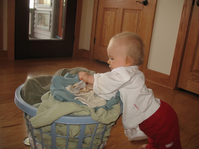She methodically takes handful after handful of stuff out of the basket and flings it to the side.  Once she has it all out, she generally turns around to the piles and starts flinging them apart, too.