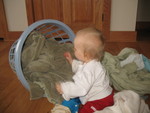 Turning the basket on its side to make it easier to get the laundry out