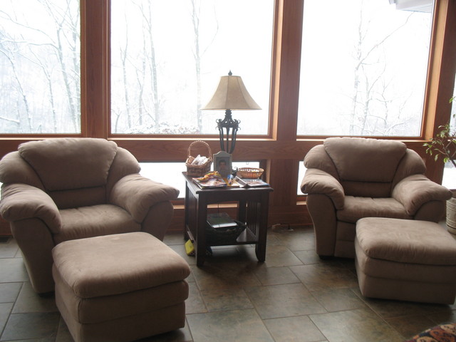 Closer view of chairs. Ottomans can be scooted away from the chairs for additional impromptu seating.  Still need to clear the table post-rearranging -- it has everything from both tables and the floor in this pic.