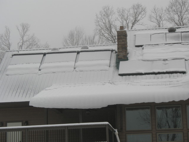 Amazingly, the solar panels still produced electricity under all this snow!  (Only enough to power a 40-watt bulb, though.)