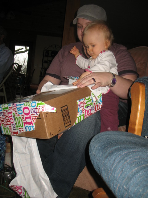Aunt Amy helping Brianna open a gift