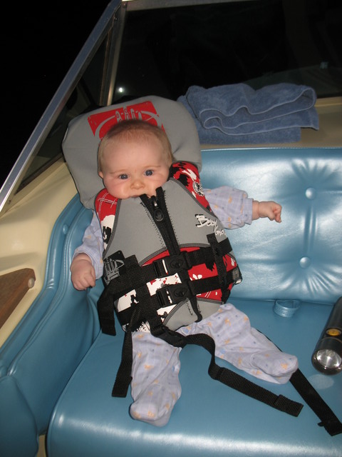 Brianna's first ride in a boat.  She is totally baffled as to why anyone would want to wear a life jacket, but tolerating it patiently.