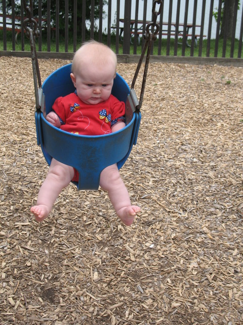 July 8: Brianna's first time in a park swing. She isn't sure what to think.