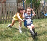 Kailyn pushing Connor on the swing