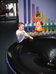 Connor laughing in delight at the balls spinning down the black hole