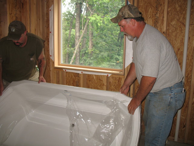 Moving the master bathtub into the bathroom