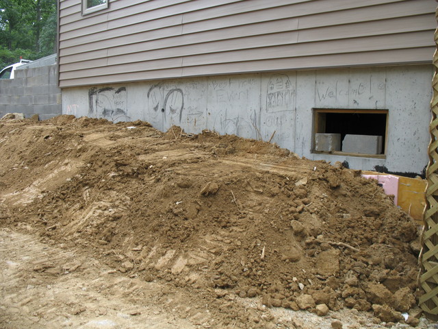Jacob moved some dirt in to start the grading for this wall