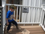 June 4: Another trip out to the decking supply place. Connor pacing off a sample deck, wearing his 