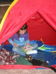 November 4: Kailyn in her tent, reading to Lucky